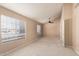 Spacious bedroom with neutral carpet, ceiling fan, and ample natural light from multiple windows at 7737 W Cherry Hills Dr, Peoria, AZ 85345