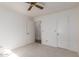 Bedroom with a ceiling fan, neutral carpet, and 2 wardrobe-style closets at 7737 W Cherry Hills Dr, Peoria, AZ 85345