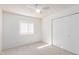 Bedroom with neutral carpet, a ceiling fan, a window and a wardrobe closet at 7737 W Cherry Hills Dr, Peoria, AZ 85345