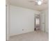 Bedroom with neutral carpet and a ceiling fan and an open door leading to another room at 7737 W Cherry Hills Dr, Peoria, AZ 85345