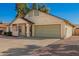 Charming single-story home featuring a two car garage and a desert landscaped front yard at 7737 W Cherry Hills Dr, Peoria, AZ 85345