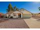 Charming single-story home featuring a two car garage and a desert landscaped front yard at 7737 W Cherry Hills Dr, Peoria, AZ 85345