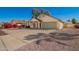 Charming single-story home featuring a two car garage and a desert landscaped front yard at 7737 W Cherry Hills Dr, Peoria, AZ 85345