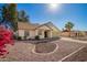 Charming single-story home featuring a two car garage and a desert landscaped front yard at 7737 W Cherry Hills Dr, Peoria, AZ 85345