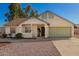 Charming single-story home featuring a two car garage and a desert landscaped front yard at 7737 W Cherry Hills Dr, Peoria, AZ 85345