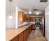 Well-lit kitchen featuring stainless steel appliances, tile floor, and wood cabinets at 7737 W Cherry Hills Dr, Peoria, AZ 85345