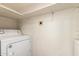 Laundry room with a white dryer in a bright white room and a simple shelf above at 7737 W Cherry Hills Dr, Peoria, AZ 85345