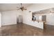 Open-concept living room with tile floors, high ceilings and a breakfast bar overlooking the kitchen at 7737 W Cherry Hills Dr, Peoria, AZ 85345