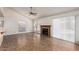 Bright living room featuring a fireplace, large windows with blinds and tile flooring at 7737 W Cherry Hills Dr, Peoria, AZ 85345