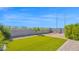 Featuring artificial grass, gravel, and landscaping. Surrounded by block wall at 7751 W Forest Grove Ave, Phoenix, AZ 85043