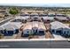 Wide aerial view of a home with a tile roof, desert landscaping, and well-maintained neighborhood at 8009 W Northview Ave, Glendale, AZ 85303