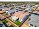 An aerial view displays a cozy backyard featuring a covered patio, lush lawn, and secure fencing at 8009 W Northview Ave, Glendale, AZ 85303