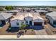 An aerial view of a home with a tile roof and a well-manicured yard in a desert landscape at 8009 W Northview Ave, Glendale, AZ 85303