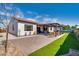 Backyard featuring a covered patio and faux grass at 8009 W Northview Ave, Glendale, AZ 85303