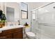 Well-lit bathroom featuring a glass-enclosed shower, modern fixtures, and clean design at 8009 W Northview Ave, Glendale, AZ 85303