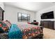 Bedroom featuring carpet, a dark wood bed, and a view at 8009 W Northview Ave, Glendale, AZ 85303