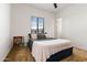 Cozy bedroom with plush carpeting, a comfortable bed, and a window offering natural light at 8009 W Northview Ave, Glendale, AZ 85303