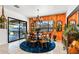 Bright dining room with a blue rug, modern lighting, and access to the outdoor patio at 8009 W Northview Ave, Glendale, AZ 85303