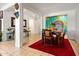 Bright dining room featuring a decorative red rug and painted wall mural, perfect for entertaining guests at 8009 W Northview Ave, Glendale, AZ 85303