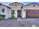 Charming home with a two-car garage, desert landscaping, and a stone pathway leading to the front door at 8009 W Northview Ave, Glendale, AZ 85303