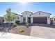 Single-story home featuring desert landscaping, a two-car garage, and a well-maintained front yard at 8009 W Northview Ave, Glendale, AZ 85303