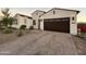 Inviting home features a paver driveway, desert landscaping, and a two-car garage with modern lighting at 8009 W Northview Ave, Glendale, AZ 85303