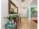 Hallway features tiled floors, decorative mirrors and lighting, creating a welcoming atmosphere at 8009 W Northview Ave, Glendale, AZ 85303