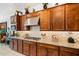 Well-equipped kitchen boasting ample cabinetry, granite counters, and a stylish tile backsplash at 8009 W Northview Ave, Glendale, AZ 85303