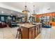 Open concept kitchen with a large island, counter seating, and seamless connection to the living spaces at 8009 W Northview Ave, Glendale, AZ 85303