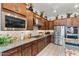 Updated kitchen featuring stainless steel appliances, granite countertops, and mosaic backsplash at 8009 W Northview Ave, Glendale, AZ 85303