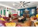 Spacious living room featuring a large sectional, vibrant rug, and entertainment center with desert-themed artwork at 8009 W Northview Ave, Glendale, AZ 85303