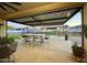 Inviting covered patio features a dining area and desert-themed mural, perfect for outdoor entertaining at 8009 W Northview Ave, Glendale, AZ 85303