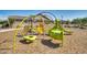 Community playground features colorful, modern equipment and a soft, wood-chip ground for safe play at 8009 W Northview Ave, Glendale, AZ 85303