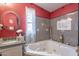 Bright bathroom features a jacuzzi tub with decorative walls and a marble countertop sink at 8126 E Billings St, Mesa, AZ 85207