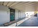 Covered carport leads to the home's entrance with a secure door and ample shade at 8126 E Billings St, Mesa, AZ 85207