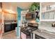 Updated kitchen featuring modern appliances, mosaic backsplash and adjacent laundry area at 8126 E Billings St, Mesa, AZ 85207