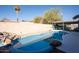 Beautiful pool area with a rock waterfall feature and a covered patio, perfect for relaxation at 8126 E Billings St, Mesa, AZ 85207