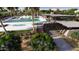 Aerial view of the luxurious community pool, spa, and cabana area surrounded by palm trees and lush greenery at 8149 E Petunia Ave # 1041, Mesa, AZ 85212