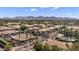 Expansive aerial view of a well-maintained community, showcasing the lush landscaping, homes, and mountain backdrop at 8180 E Shea Blvd # 1038, Scottsdale, AZ 85260