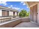 A spacious balcony with wrought iron railings, offering views of the lush landscaping and blue sky at 8180 E Shea Blvd # 1038, Scottsdale, AZ 85260