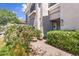 Inviting home entrance framed with lush flowering bushes at 8180 E Shea Blvd # 1038, Scottsdale, AZ 85260