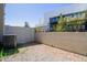 A fenced backyard space with minimalist landscaping and a clear view of the modern architectural building at 8188 N 22Nd Dr, Phoenix, AZ 85021