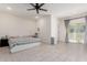 The bright bedroom features light tile flooring, a ceiling fan, and access to a private balcony at 8188 N 22Nd Dr, Phoenix, AZ 85021