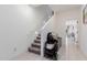 Hallway with carpeted stairs, tiled flooring, and ample lighting gives a modern and inviting feel at 8188 N 22Nd Dr, Phoenix, AZ 85021