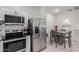 Open kitchen layout with stainless steel appliances and tile backsplash, flowing into the adjacent dining area at 8188 N 22Nd Dr, Phoenix, AZ 85021