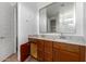 Bathroom with granite counters, double sinks, dark wood cabinets, and a large mirror at 9313 S 39Th Dr, Laveen, AZ 85339