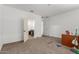 Empty bedroom with carpet, white walls, closet doors and a doorway leading to the attached bathroom at 9313 S 39Th Dr, Laveen, AZ 85339