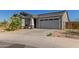 Single-story home with desert landscaping and a driveway and two-car garage at 9313 S 39Th Dr, Laveen, AZ 85339