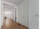 Hallway with white walls, tile floors, and neutral-colored doors at 9313 S 39Th Dr, Laveen, AZ 85339