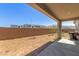 Covered patio overlooking a dirt backyard, enclosed by a brick wall, with mountain views at 9313 S 39Th Dr, Laveen, AZ 85339